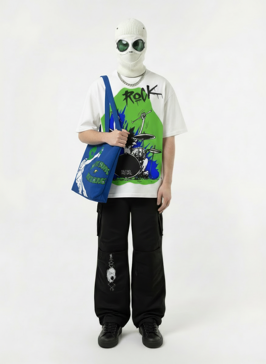 Person wearing a white mask, graphic t-shirt, and black pants holding a blue tote bag on a white background