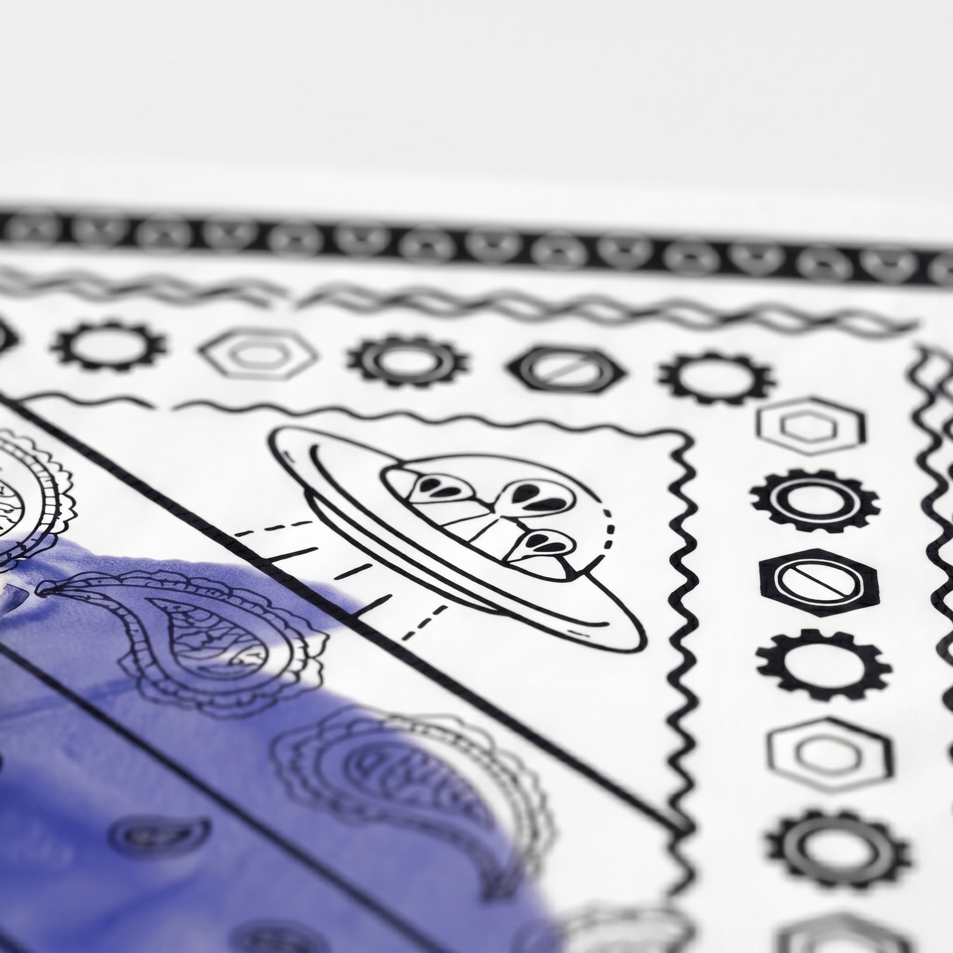 Close-up of a sheet with black line art designs on a white background